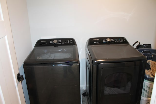 washroom with laundry area and washer and dryer