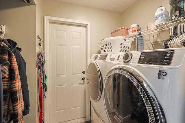 laundry room with laundry area, a textured ceiling, and separate washer and dryer