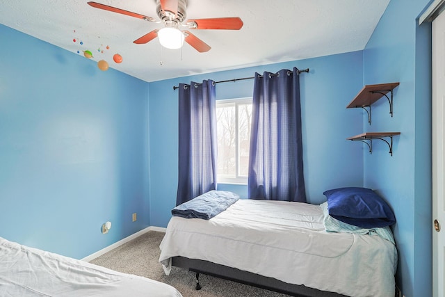 carpeted bedroom featuring a ceiling fan and baseboards