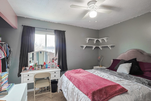 bedroom featuring light carpet, a textured ceiling, and a ceiling fan