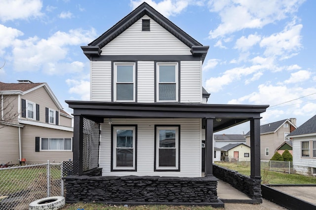 view of front of property featuring a porch and fence