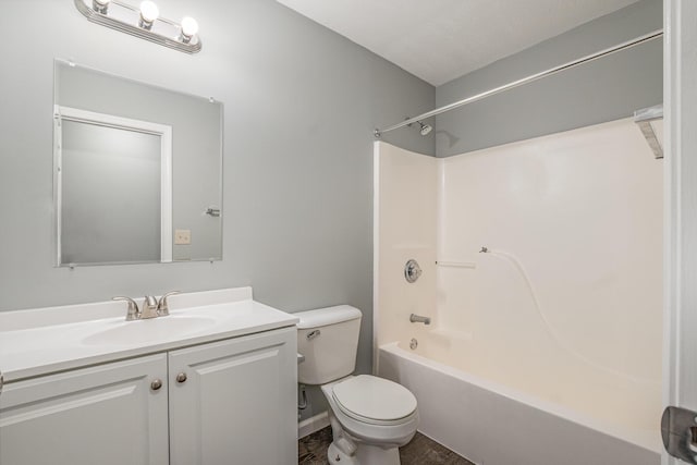 bathroom featuring tub / shower combination, vanity, and toilet