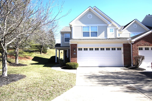 traditional-style house with a garage, driveway, brick siding, and a front lawn