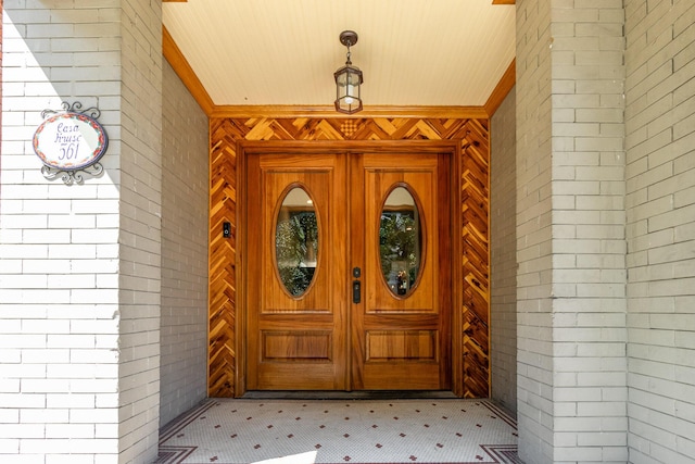 property entrance featuring brick siding