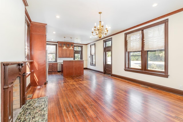 kitchen featuring dark wood-style floors, a center island, dishwasher, brown cabinetry, and crown molding