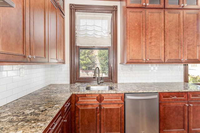 kitchen featuring glass insert cabinets, a sink, dishwasher, and light stone countertops