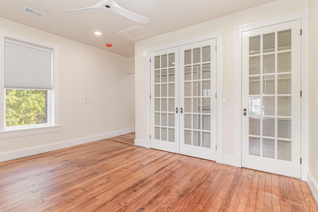 spare room with visible vents, baseboards, wood-type flooring, ceiling fan, and french doors