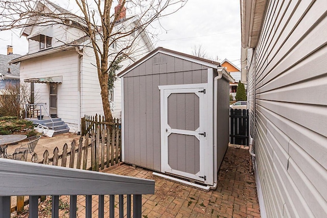 view of shed featuring fence