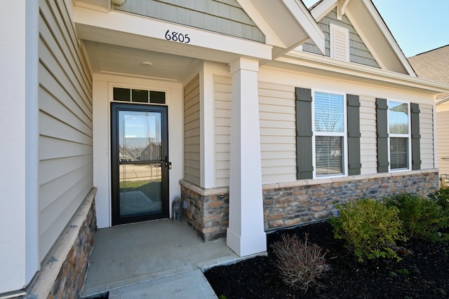 doorway to property with stone siding