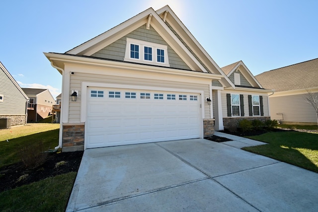 craftsman inspired home featuring stone siding, an attached garage, driveway, and a front yard