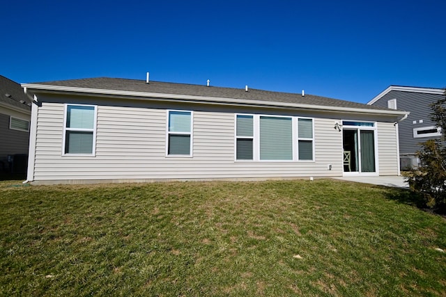 back of property with a lawn and a patio