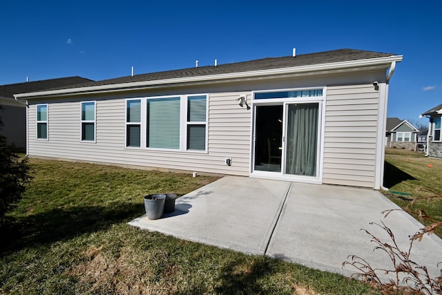 back of house with a patio and a lawn