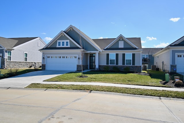 craftsman inspired home with central AC unit, a garage, concrete driveway, stone siding, and a front lawn