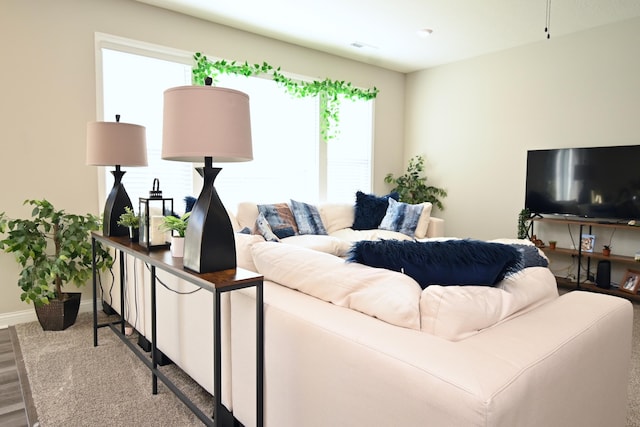 living area with light wood-type flooring and baseboards