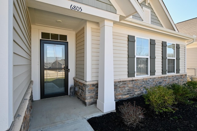 doorway to property featuring stone siding