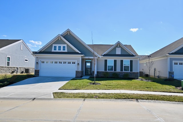 craftsman-style house with driveway, stone siding, an attached garage, and a front yard