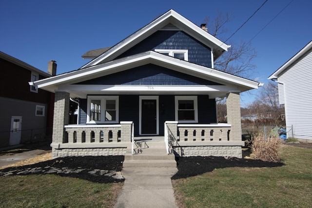 view of front of property with covered porch and brick siding