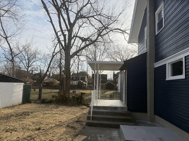 view of yard featuring fence and a porch