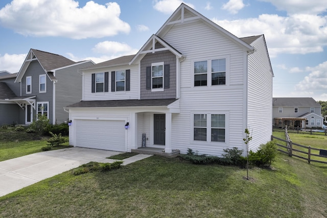 view of front of home featuring driveway, a front yard, and fence