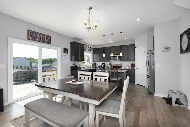 dining room with baseboards, a chandelier, dark wood-type flooring, and recessed lighting