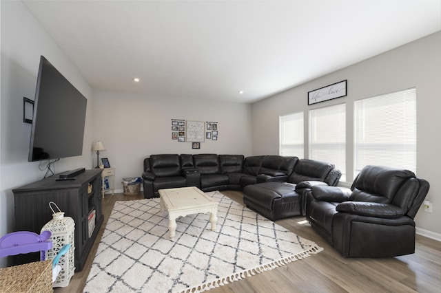 living area with baseboards, wood finished floors, and recessed lighting