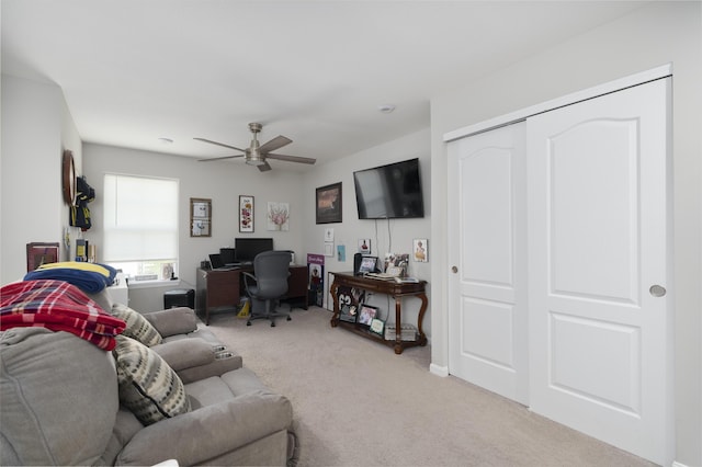 living room with a ceiling fan and light carpet