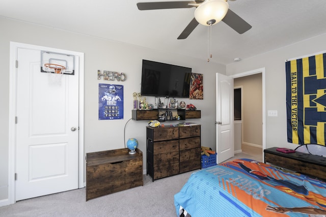 bedroom with a ceiling fan and light colored carpet