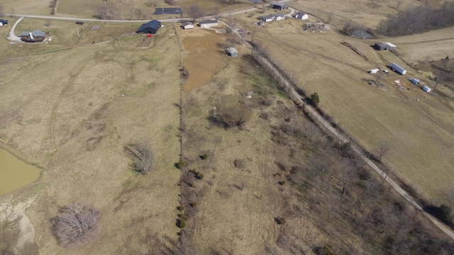 birds eye view of property with a water view and a rural view