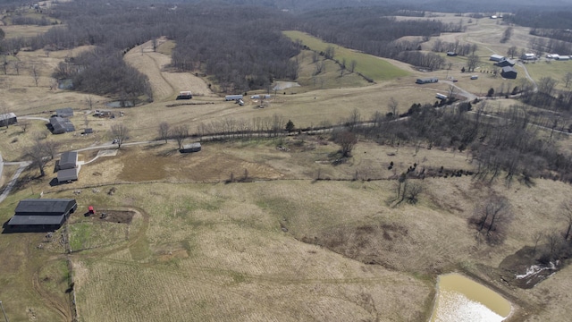 birds eye view of property featuring a water view and a rural view