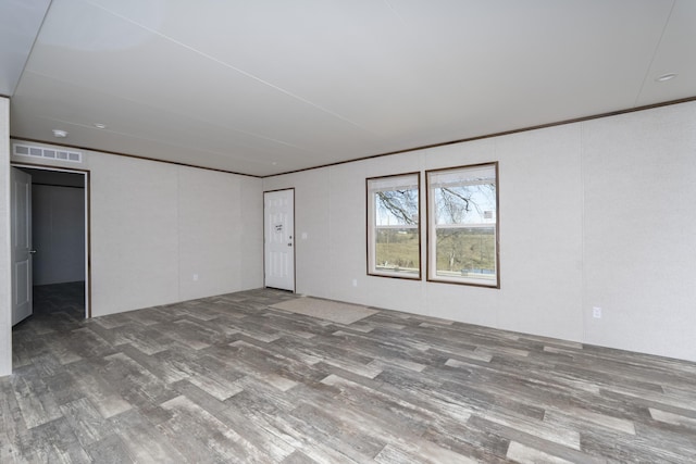 empty room with visible vents and wood finished floors