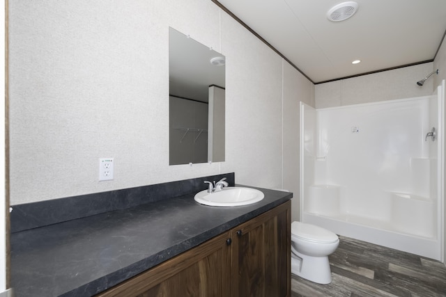 full bath featuring toilet, wood finished floors, and vanity