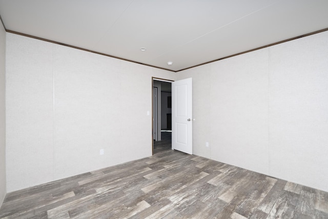 unfurnished room featuring ornamental molding and wood finished floors