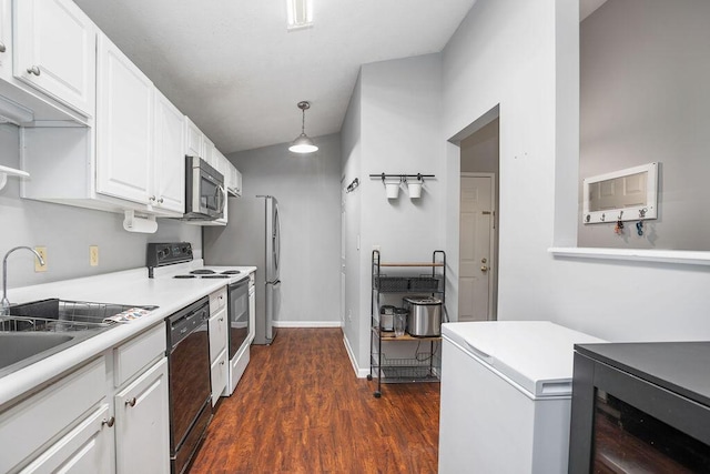 kitchen with decorative light fixtures, dark wood finished floors, stainless steel appliances, light countertops, and white cabinets