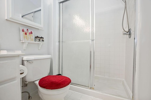 bathroom with a stall shower, vanity, and toilet