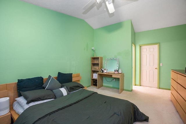 bedroom featuring lofted ceiling, baseboards, a ceiling fan, and light colored carpet