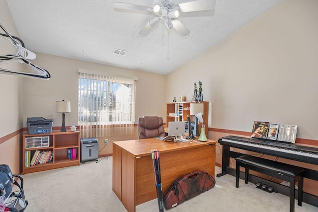 office area featuring a ceiling fan, visible vents, light carpet, and a textured ceiling