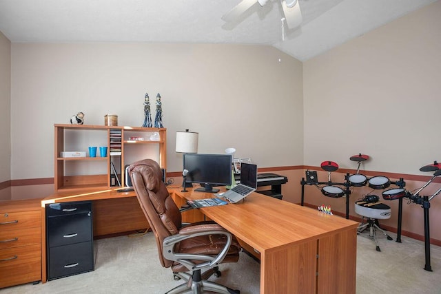 office area with lofted ceiling, a ceiling fan, and light colored carpet