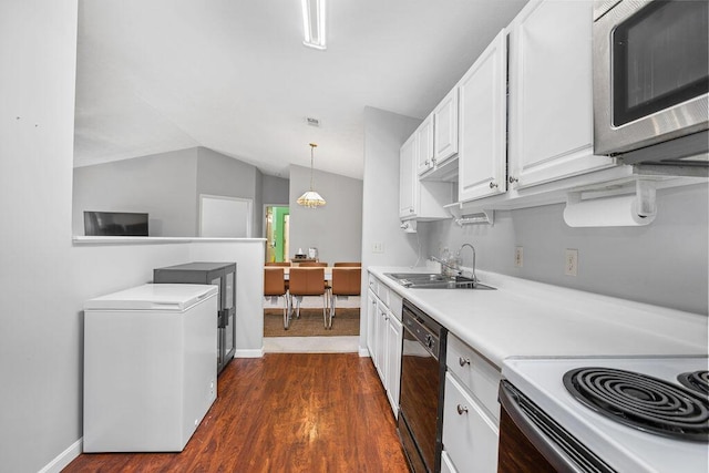 kitchen with light countertops, stainless steel microwave, white cabinetry, a sink, and dishwasher