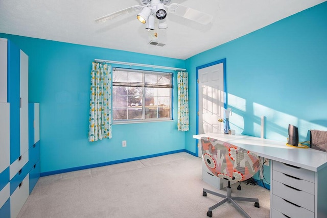 office space featuring baseboards, visible vents, a ceiling fan, and light colored carpet