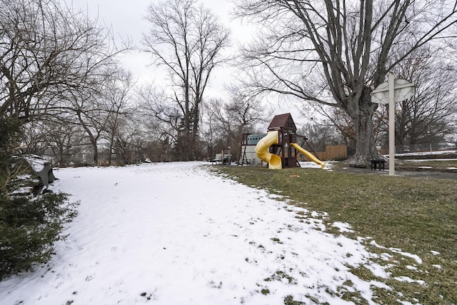 snowy yard with a playground