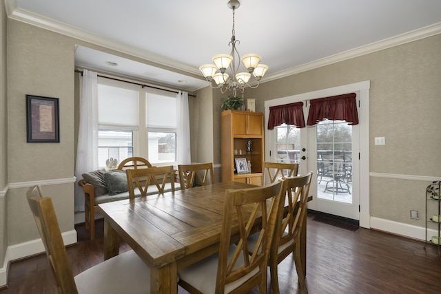 dining room with baseboards, dark wood-style flooring, a notable chandelier, and crown molding