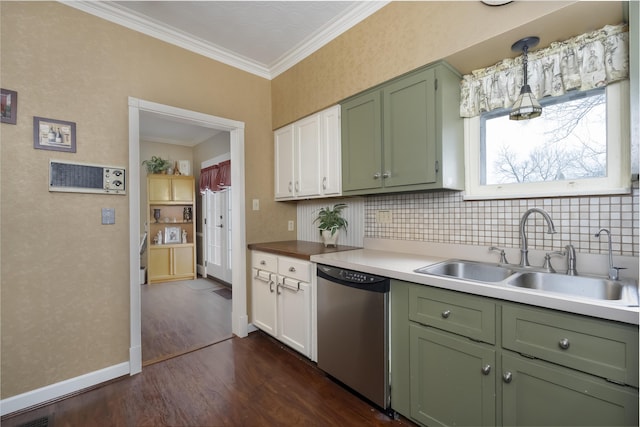 kitchen with a sink, light countertops, stainless steel dishwasher, and decorative light fixtures