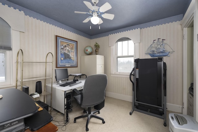 office space with wallpapered walls, baseboards, and a ceiling fan