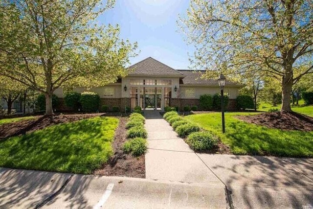 ranch-style home with brick siding and a front lawn