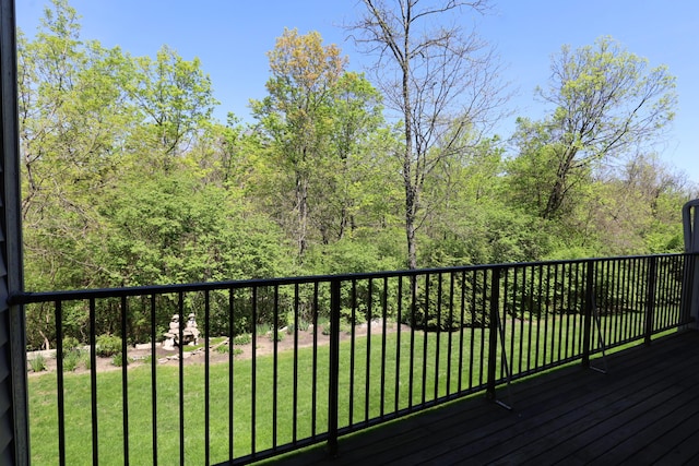 wooden deck featuring a yard