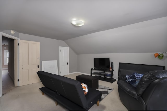 living room featuring baseboards, vaulted ceiling, and light colored carpet