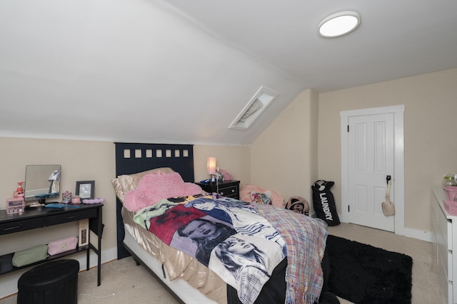 bedroom with light colored carpet, vaulted ceiling, and baseboards