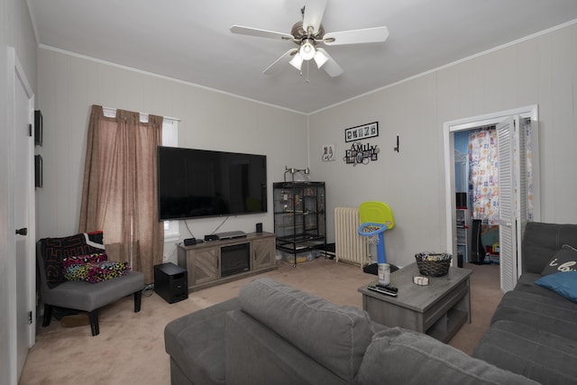 living area with light carpet, crown molding, radiator heating unit, and ceiling fan