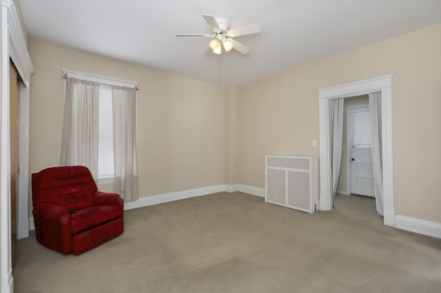 sitting room featuring light carpet, ceiling fan, visible vents, and baseboards