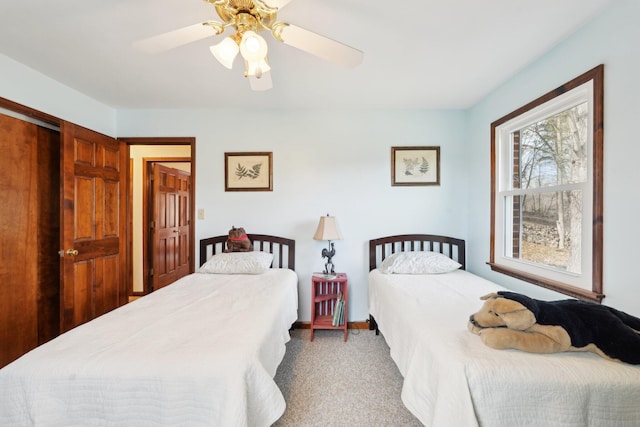 bedroom with carpet flooring, a ceiling fan, and baseboards